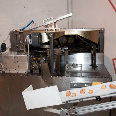 A machine for making fortune cookies on display.