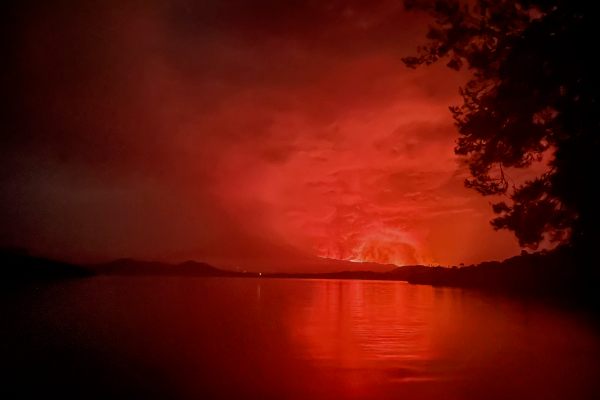 Flame spewing from the Nyiragongo Volcano, as seen across Lake Kivu. 