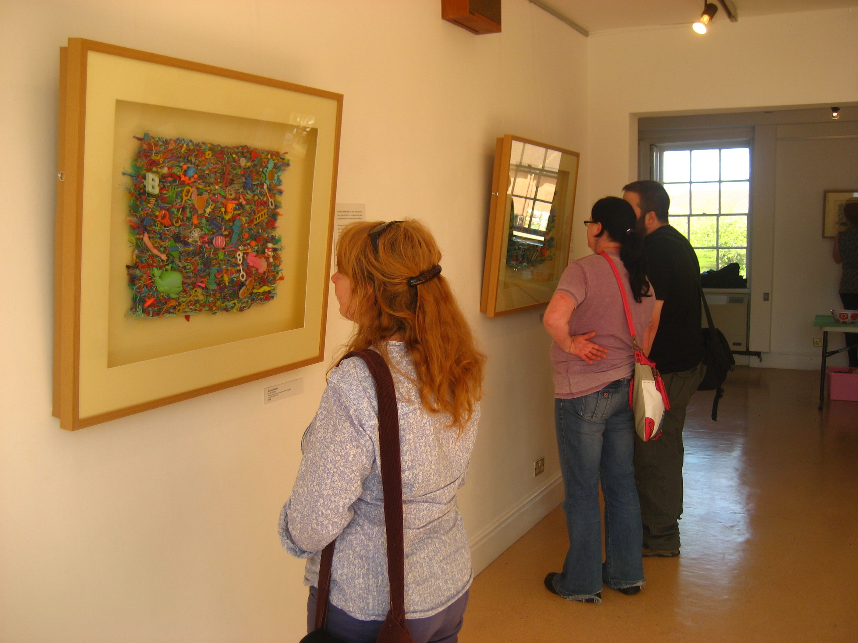 Visitors examine works of flotsam weaving at one of Jo Atherton's gallery shows.