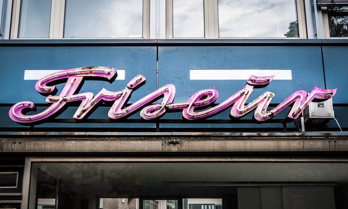 A pink neon sign for a hair stylist.