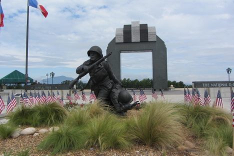 Statue of a soldier running up the beach.