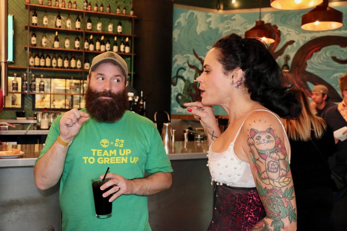 "Human blockhead" Reggie Bügmüncher entertains a volunteer as he extracts a nail from her nose.
