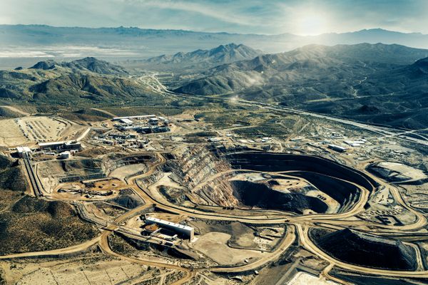 Aerial view easterly over the mine site. The main pit is just right of center.  The freeway is Interstate-15.