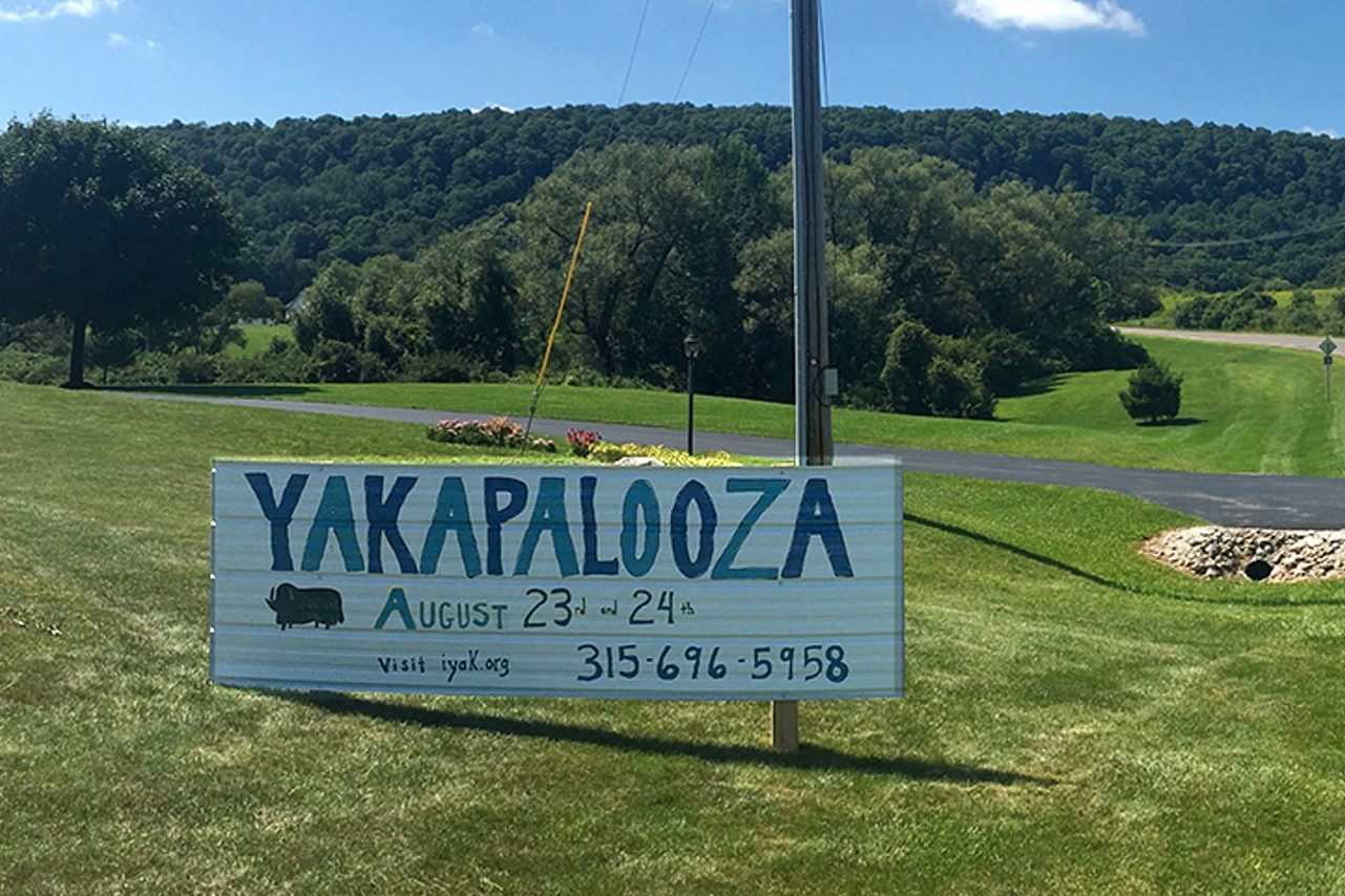 A sign on the road features the Yakapalooza event dates.
