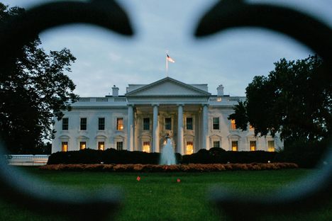 The sun rises behind the White House in 2005. 
