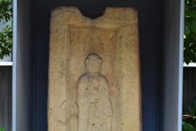 A medieval Buddha on an ancient coffin lid.