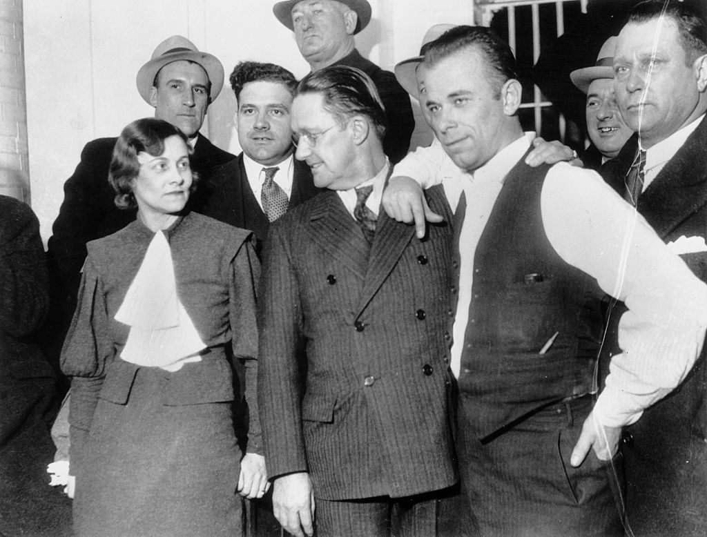 Dillinger (right, in vest) was notoriously charismatic, even when surrounded by cops.