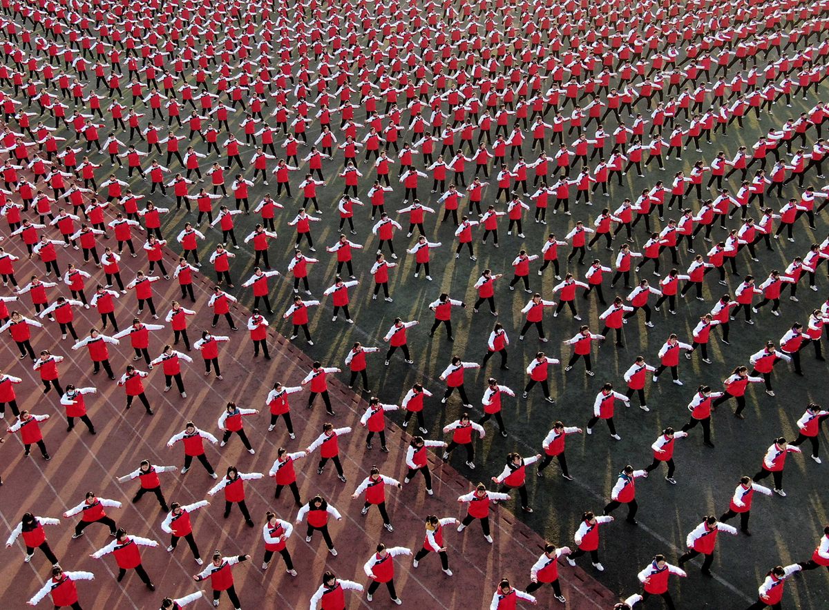 Students practice tai chi in a playground of a school in Jiaozuo City in central China's Henan Province (December 2020). 