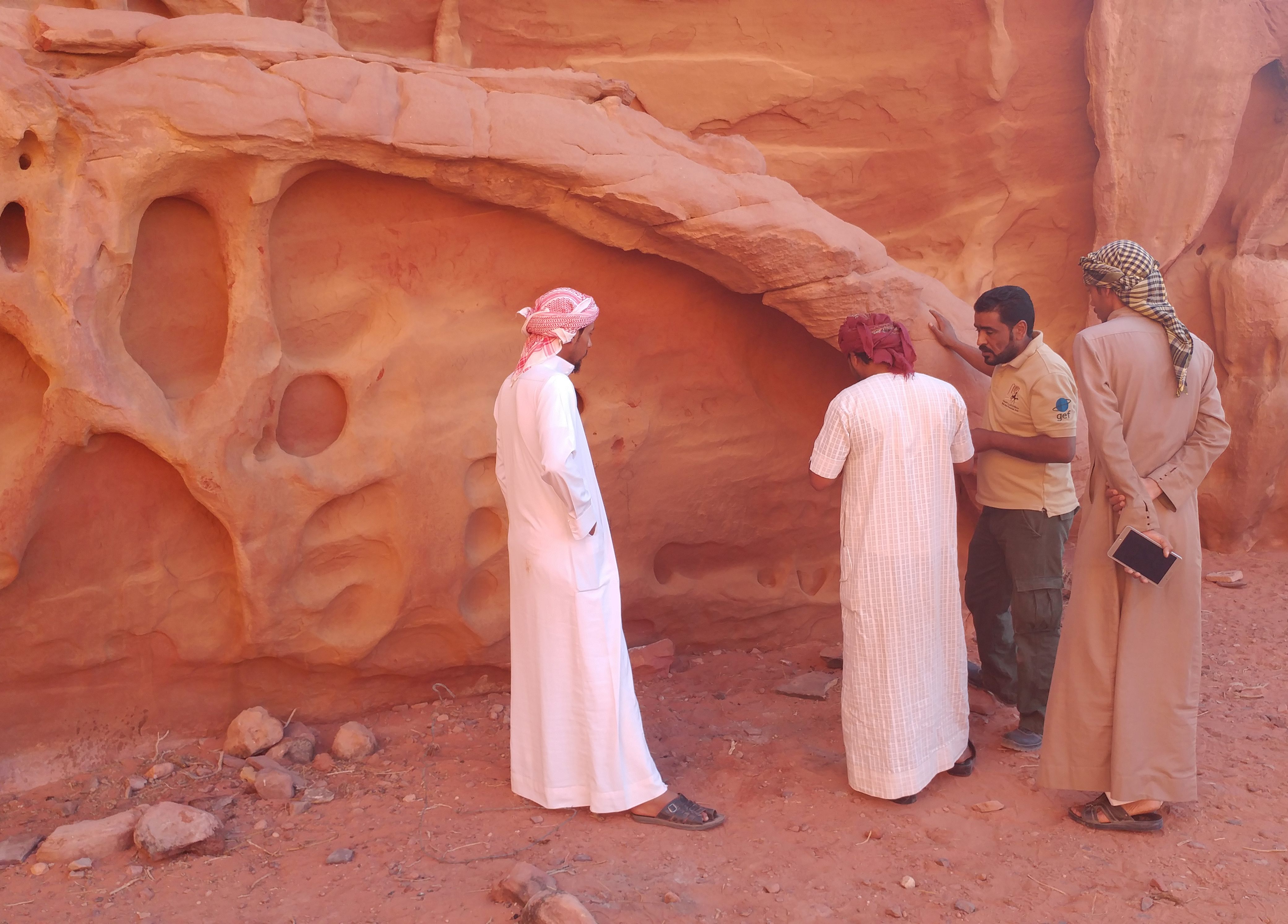 Mohammad Dmeian Al Zalabieh (second from right) teaches locals about the Rock Art Stability Index.