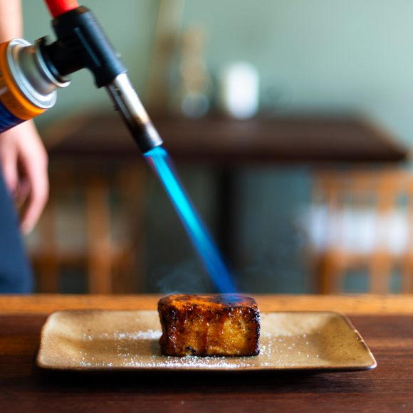 A blowtorch makes for an exquisitely caramelized crust.