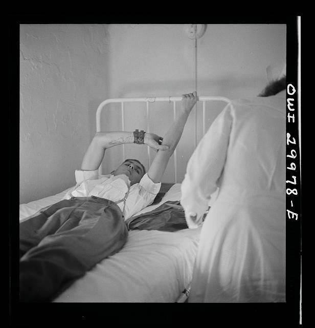 Post-donation at the D.C. Red Cross, a volunteer keeps his arm up. (Photo: Library of Congress/LC-DIG-fsa-8d30127)