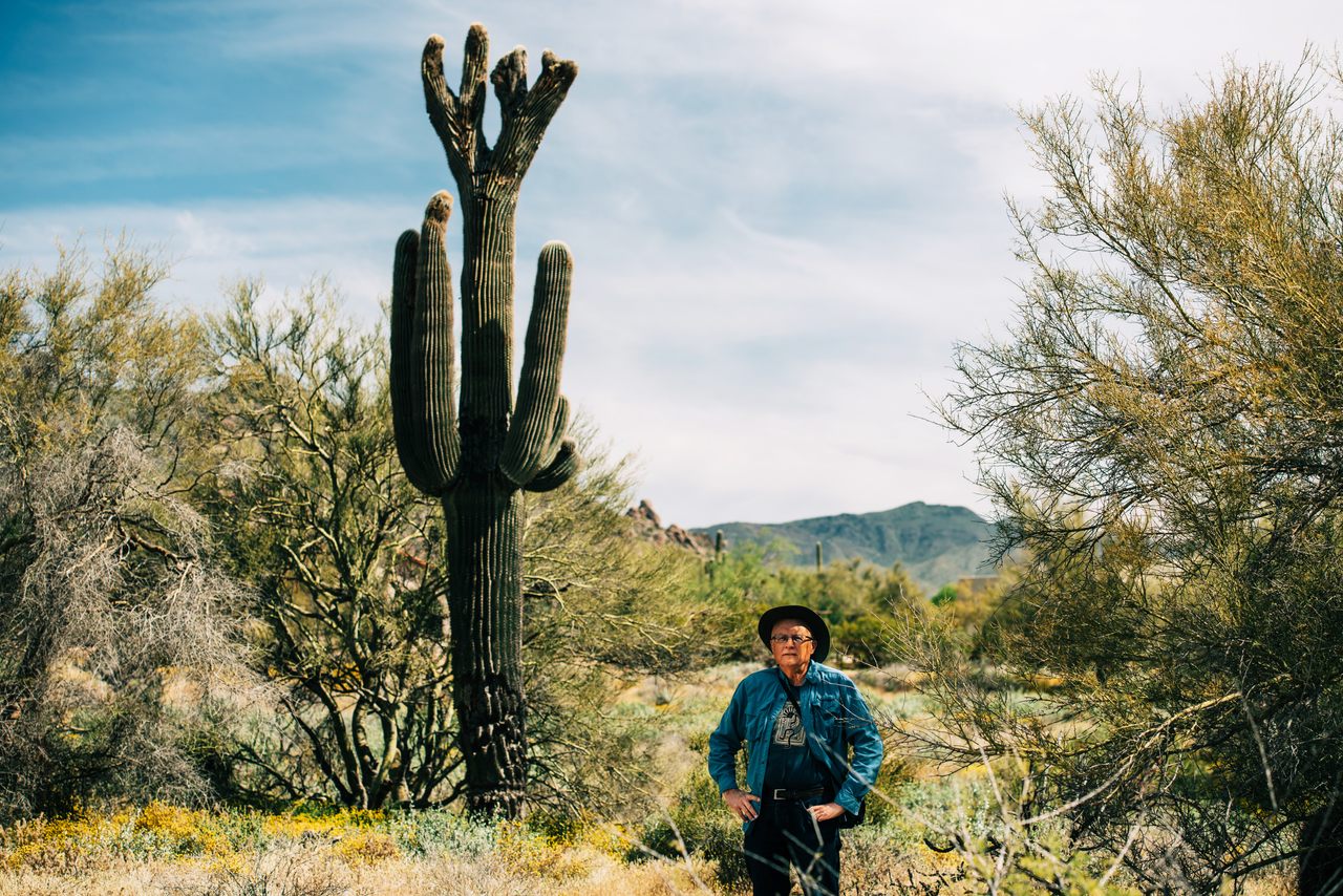 Joe Orman stands below 4 Square, one of the first crested saguaros he discovered.