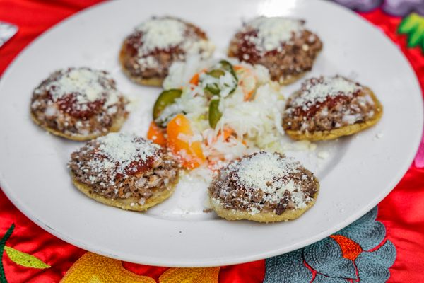 Order a round of garnachas, masa disks with shredded pork.