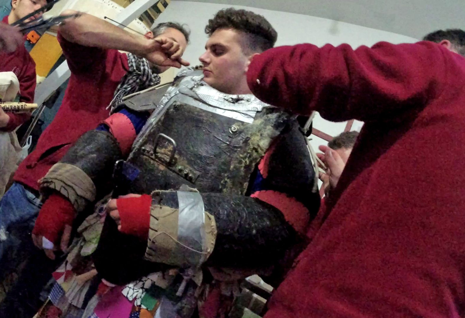 Nineteen-year-old Adrián Moreno Serrano’s <em>mayordomos</em>—family and friends—help gird him for battle in a costume that weighs more than 100 pounds.