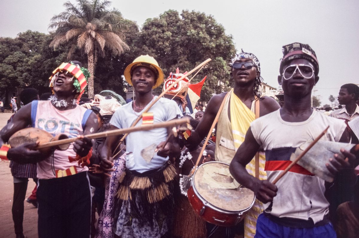 Village or neighborhood groups parade among the masked groups with music and dance.