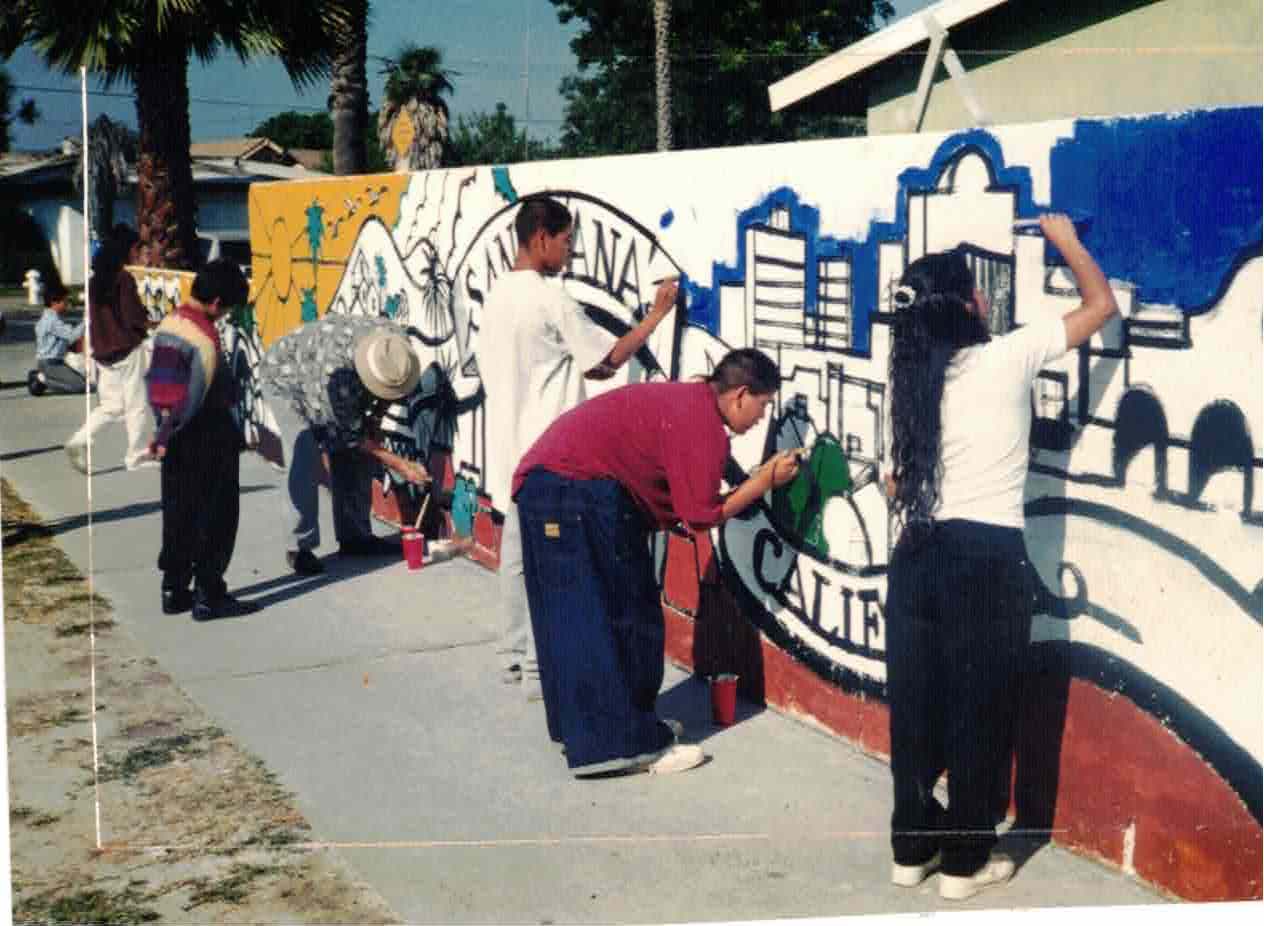 Local children paint the Raitt Street Mural in 1994, funded by the city's Safe Haven Youth Program.