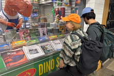 Passersby stop to admire the punny offerings of Brooklyn’s only dinosaur bodega. 