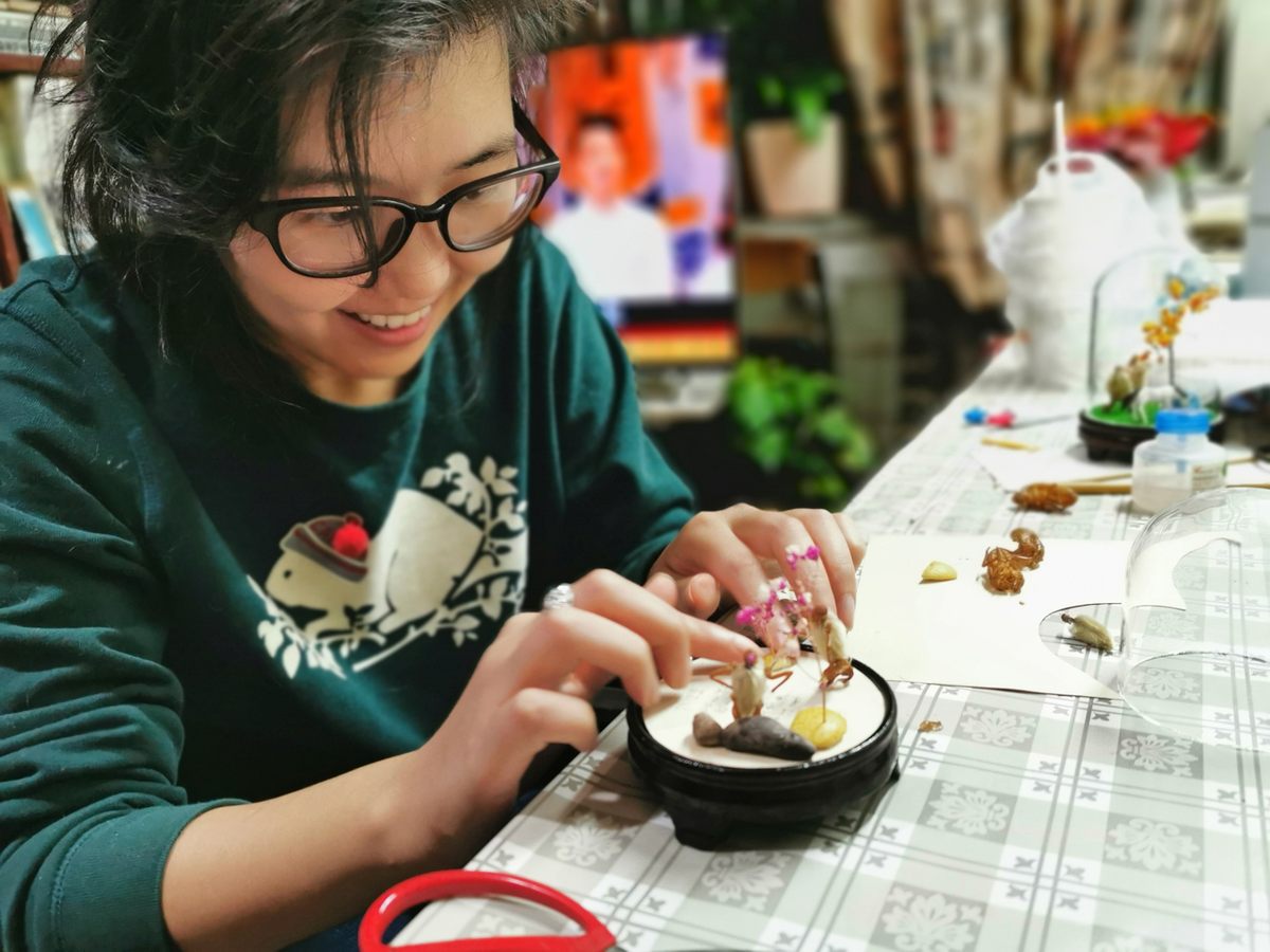 The writer, Marina Wang, is amused by her own work crafting hairy monkeys.