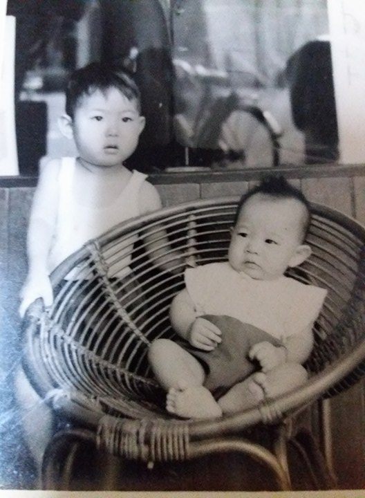 Children with a <em>kerusi rotan bulat</em>, Malaysia, late 1960s.