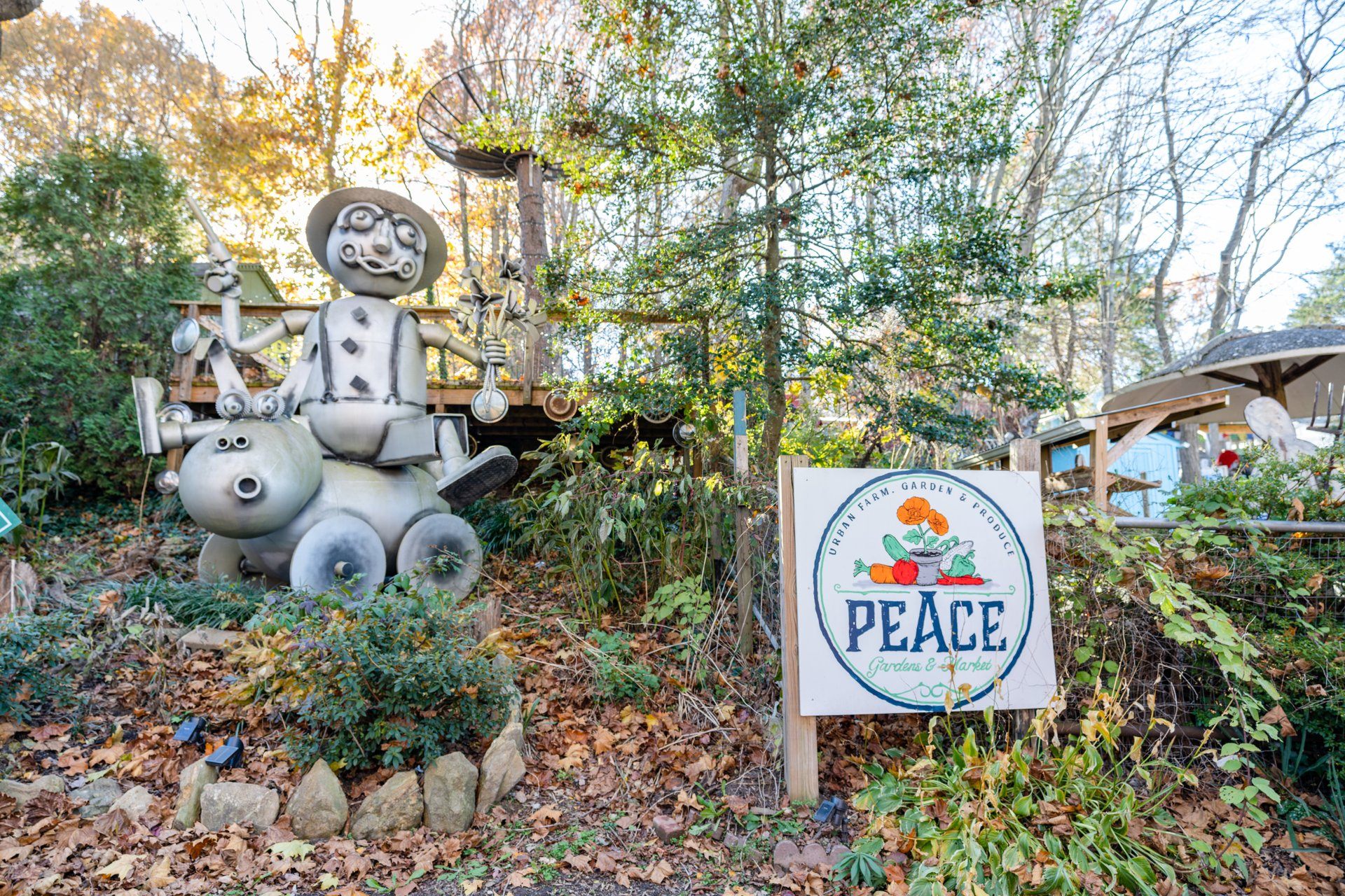 “Guns & Roses,” a.k.a. “Metal Man Riding a Pig Doug,” just one of the many artworks with Asheville’s Peace Gardens & Market. 