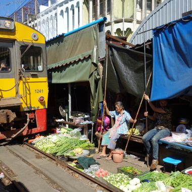 Train going over vegetables on display