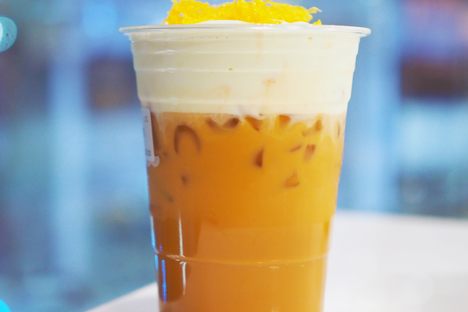 A cup of iced oolong with cheese foam and egg floss.
