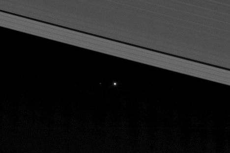Earth and the moon (on the left) from between Saturn's rings. 