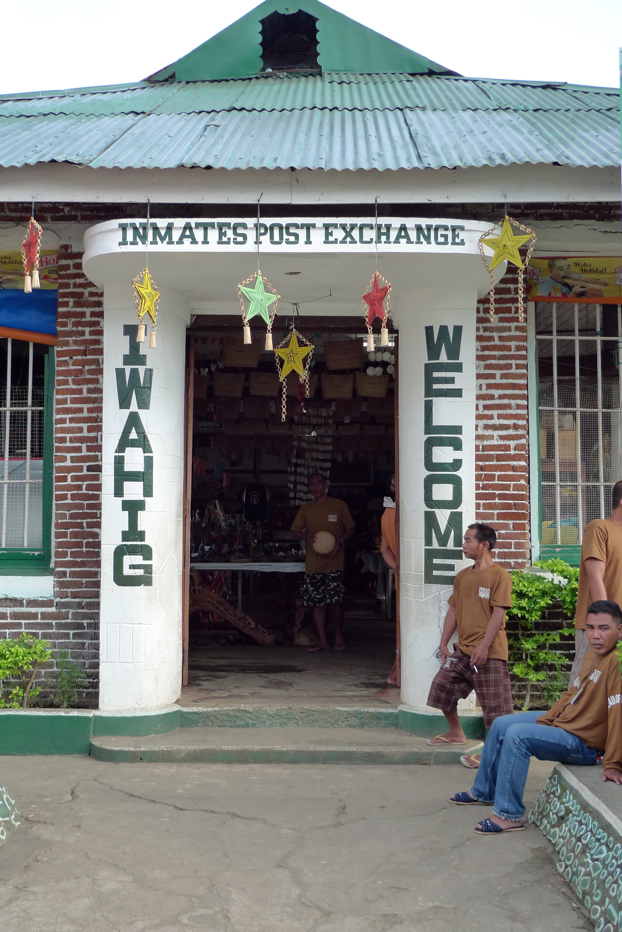 Entrance to the Iwahig Post Exchange. Minimum security inmates seated to the right.