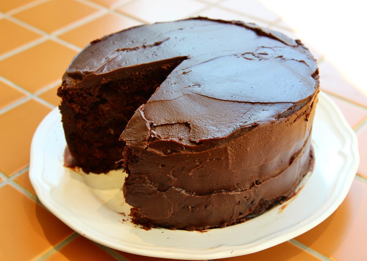 A thick chocolate ganache coats the cake layers.