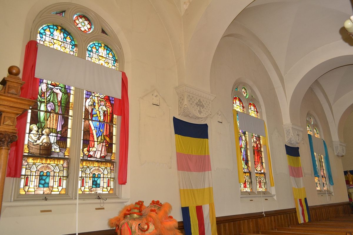 The monks hung shades and colorful fabric around the intact stained-glass windows.