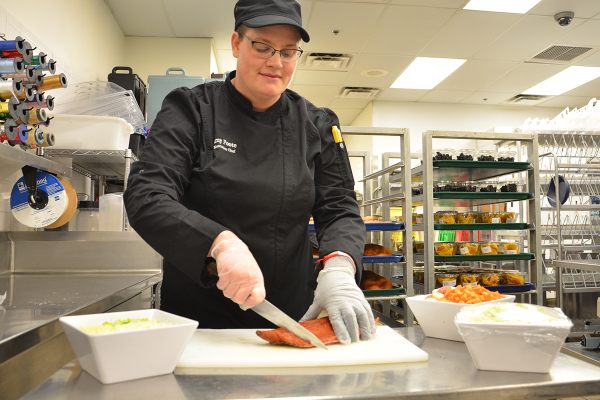 Chef Amy Foote preparing fresh Alaskan salmon for soup.
