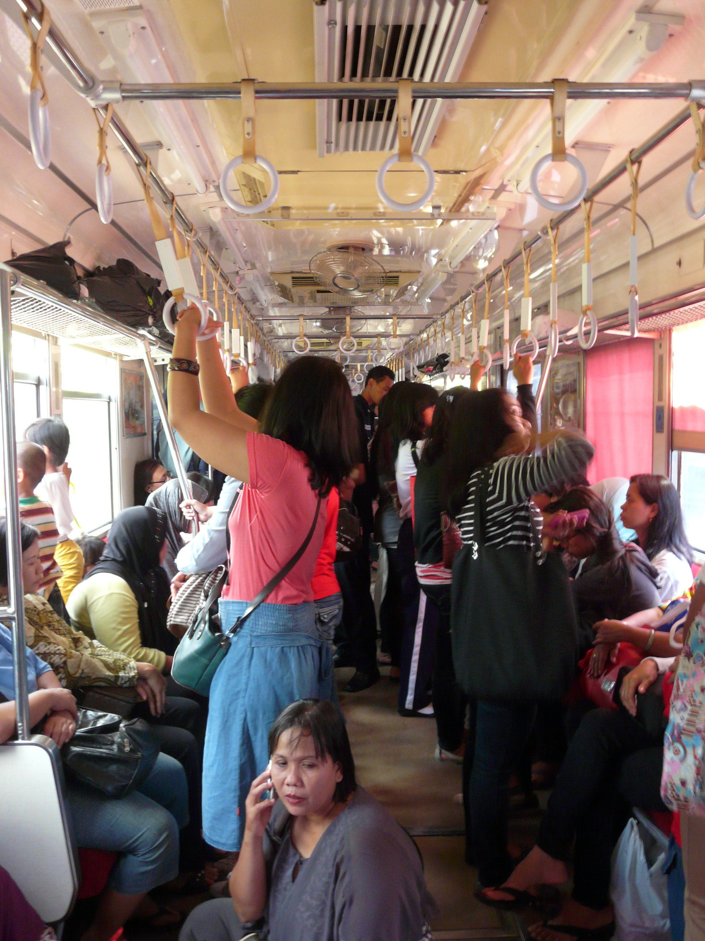 Interior of a women-only car on a KRL Jabotabek commuter train. The man pictured is a ticket inspector.