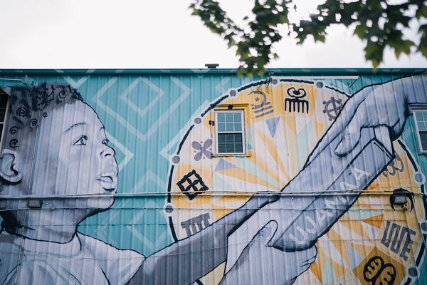 The mural on the side of the bookstore is a collaboration between “BMike” Odums and READ MORE BOOKS.