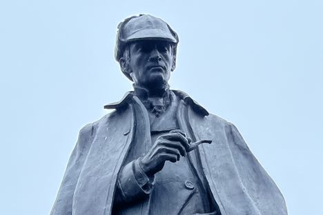 Close up of Sherlock Holmes’ face with pipe in hand