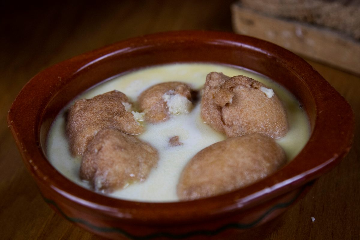 Egg-and-bread-crumb dumplings cooked in goat milk.