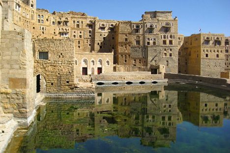 Buildings and sky reflected in the cistern.