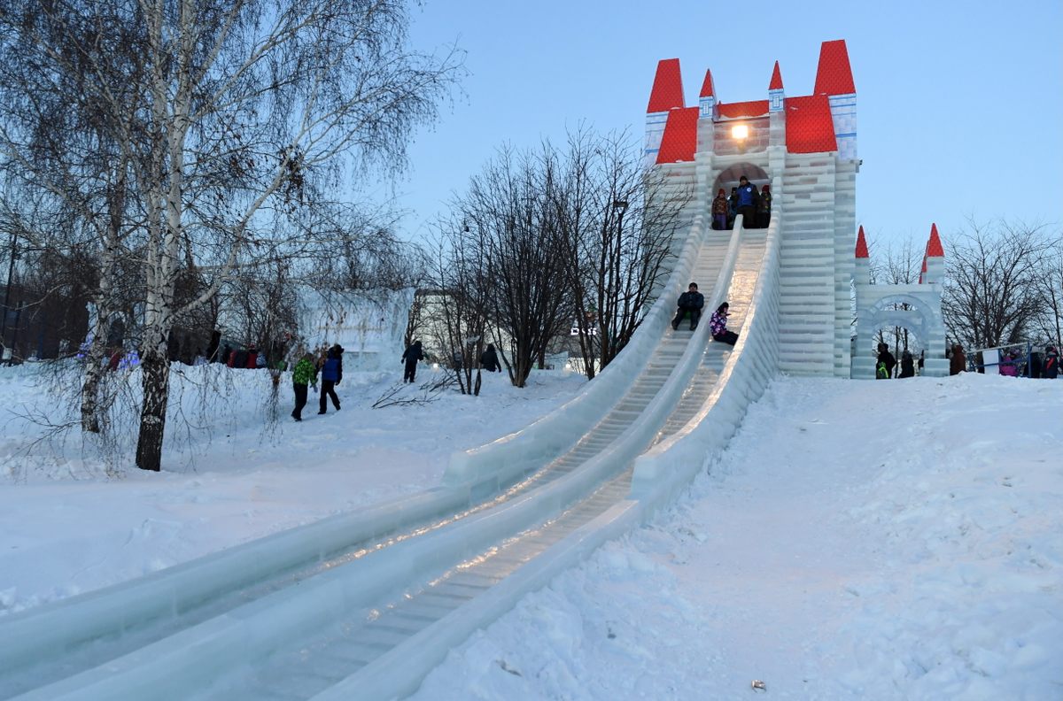 Riders on a more modest ice slide in Novosibirsk, Siberia, in December 2018.