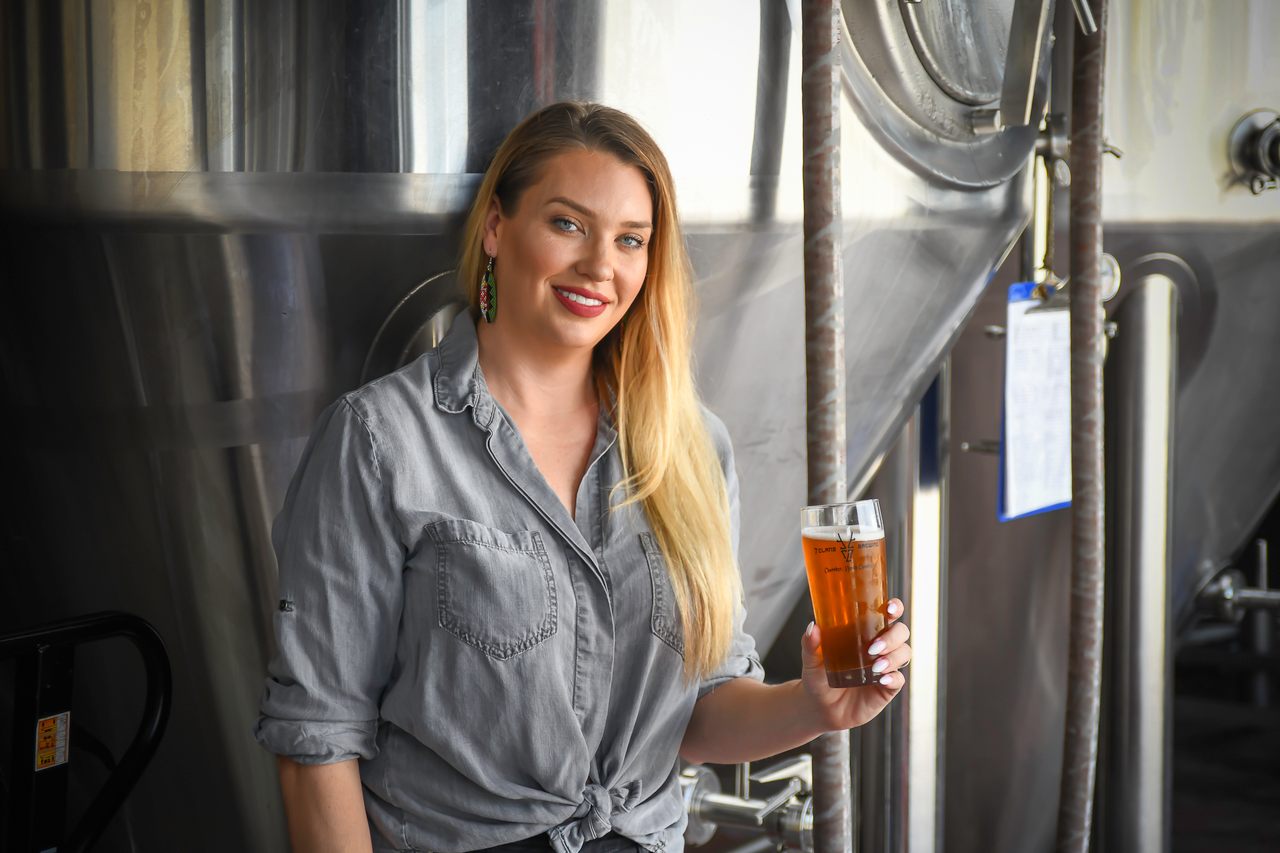 Morgan Crisp holds a beer from 7 Clans, the Native beer brand she cofounded in 2018.