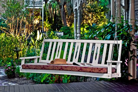 Fairbanks House rests on a beautifully landscaped acre featuring palm trees and large oaks.