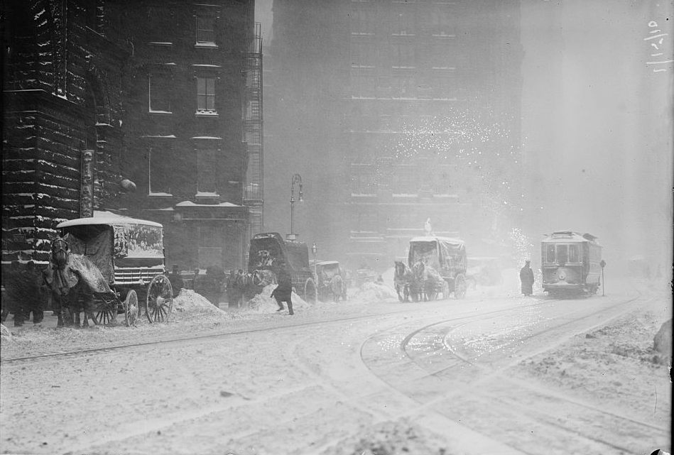 Horse-drawn wagons on snowy street, NY snow storm 1920