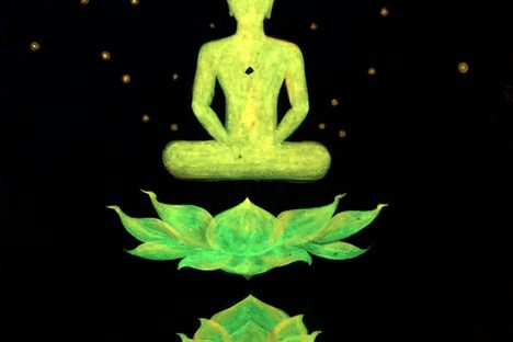 Bright Buddha images on the outer walls glow at night