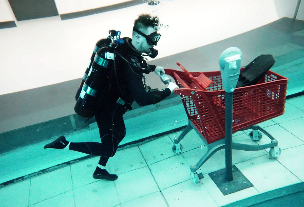 A diver uses a shopping cart at Deep Dive Dubai, the deepest swimming pool in the world at about 196 feet, complete with a "sunken city," on July 10, 2021. 