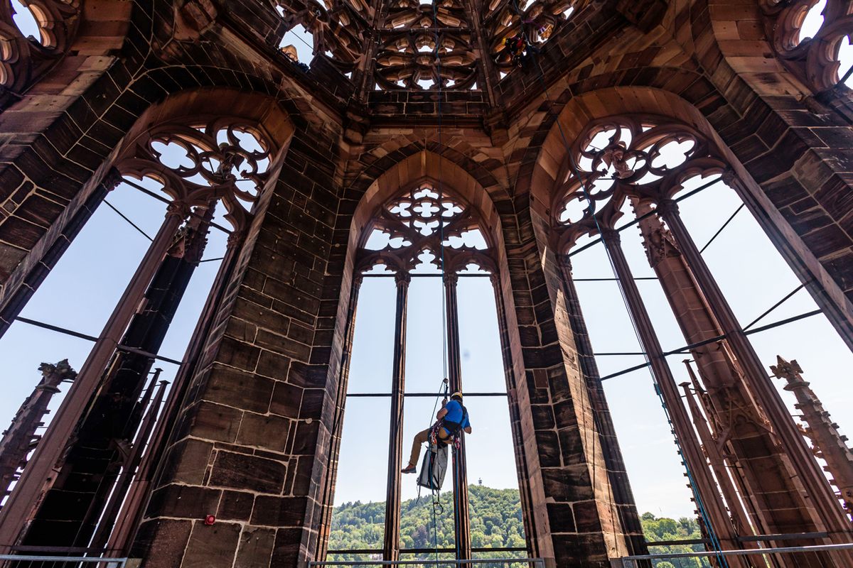 An industrial climber rappels down the inside of the tower.