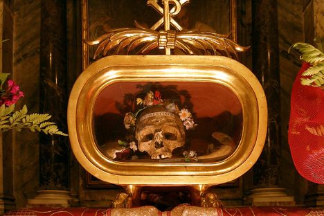 The skull is flanked by flowers.