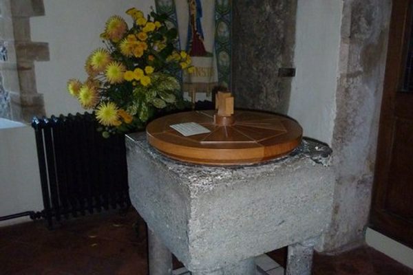The church font with the Slayer’s Slab behind