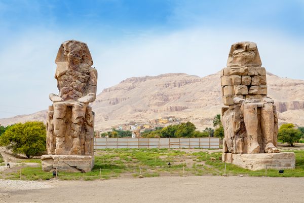 The Colossi of Memnon, battered by time and accidental Roman damage.