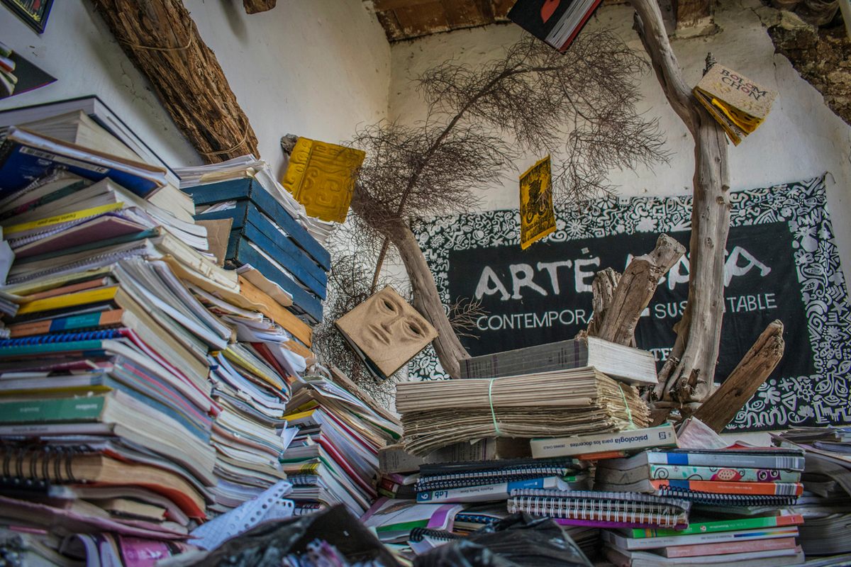 The workshop courtyard is awash in discarded paper materials, which are later recycled for making books and posters.