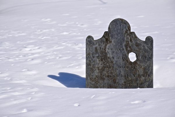 Some of the headstones have well-worn holes in them.
