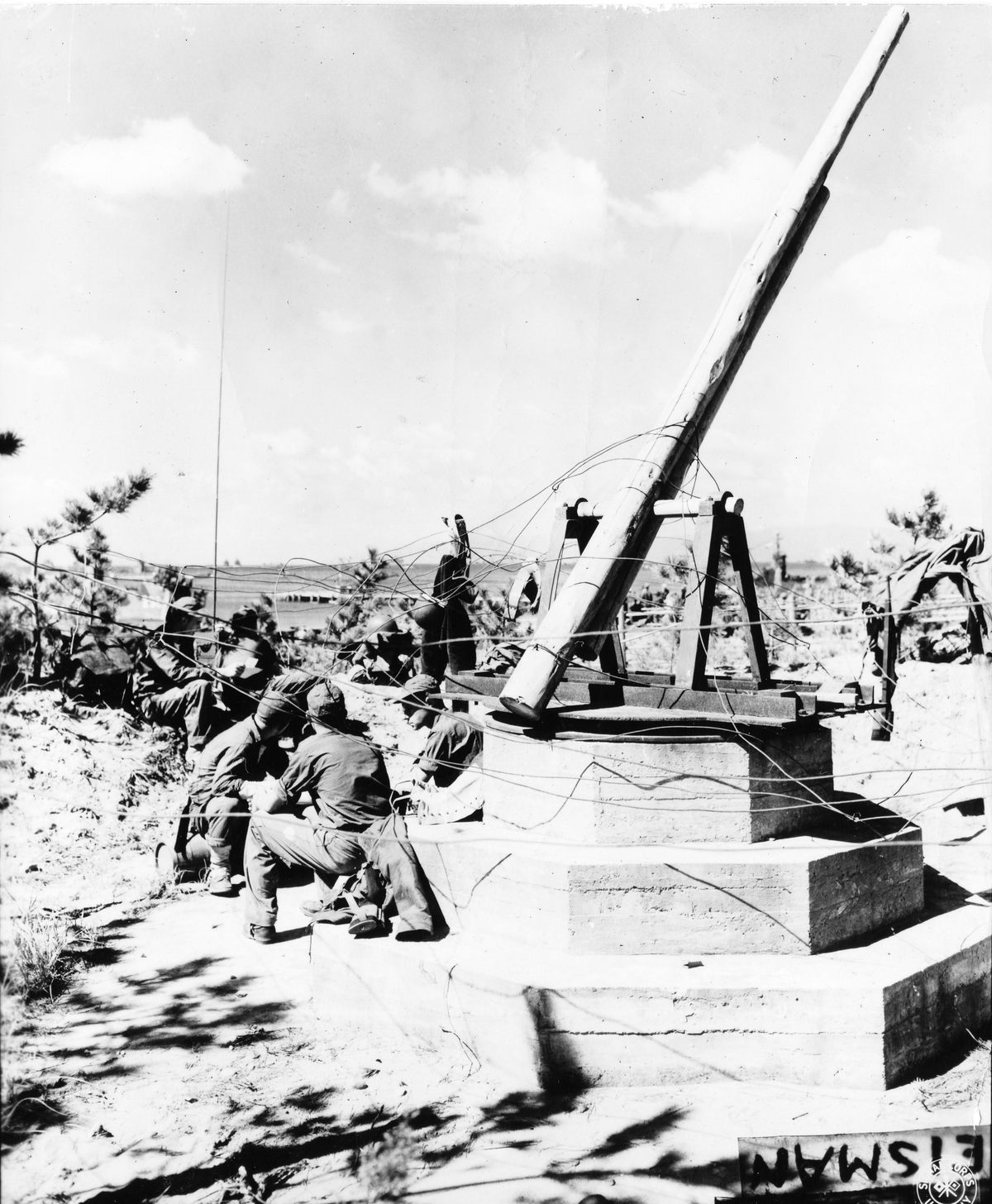 A fake Japanese AA gun constructed around a fish oil and acid producing factory off a beach in Japan.