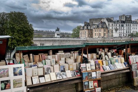 A bouquiniste, or traditional seller of vintage and antique books, on the bank of the Seine in Paris in August 2023. 